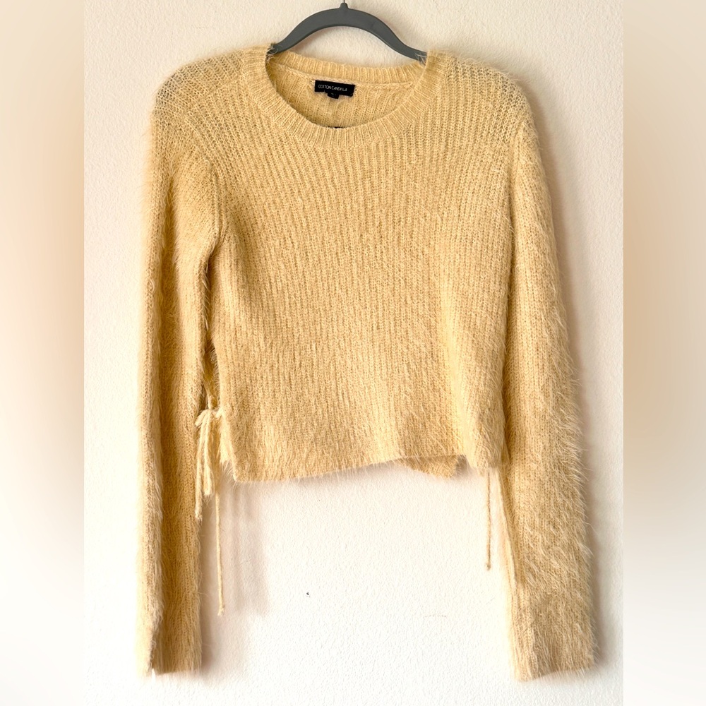 Cropped and cozy sweater with side ties.